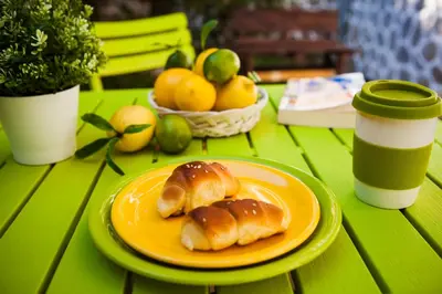 two pastries on an orange plate on a green table at Green Lime Studio in Bansko