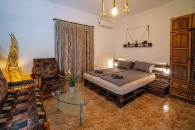 a living room with a bed and a glass table at Central Halls apartment in Sofia