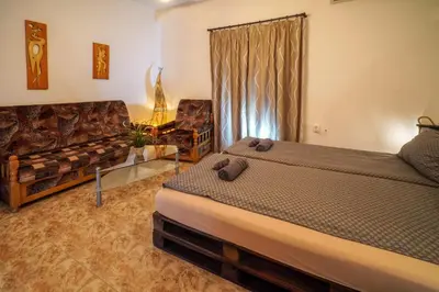 a bedroom with a bed and a couch at Central Halls apartment in Sofia