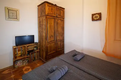 a bedroom with a bed and a tv and a cabinet at Central Halls apartment in Sofia