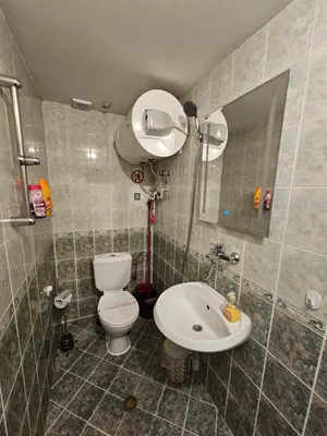 a bathroom with a toilet and a sink at Central Halls apartment in Sofia
