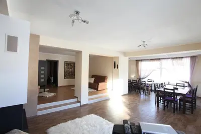 a living room and dining room with a table and chairs at Ashkova House in Govedartsi