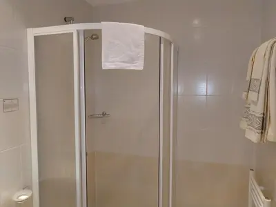 a shower with a white towel on top of it at Studio Villa Park 207 in Borovets