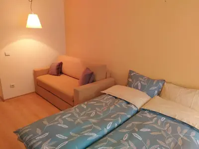 a living room with a bed and a couch at Studio Villa Park 207 in Borovets
