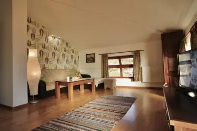 a living room with a table and a couch at Iliikova House in Kalofer