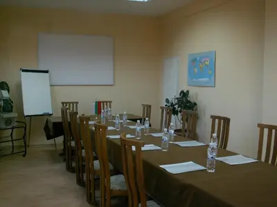 a meeting room with a long table and chairs at Dolna Bania Hotel in Dolna Banya