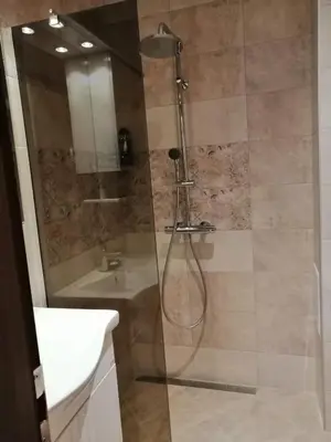 a bathroom with a shower and a sink at Апартамент Легал in Chepelare