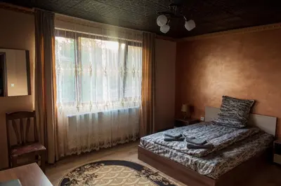 a bedroom with a bed and a window at Guest House Markovi in Govedartsi