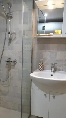 a bathroom with a sink and a glass shower at IFM Boutique studio in Plovdiv