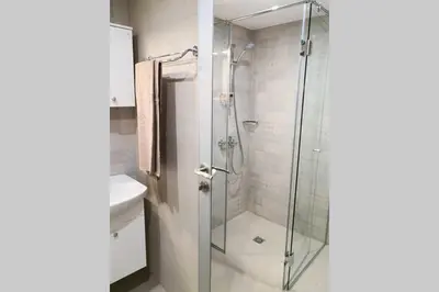 a shower with a glass door in a bathroom at IFM Boutique studio in Plovdiv