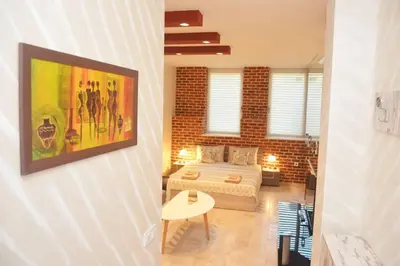 a bedroom with a bed and a brick wall at IFM Boutique studio in Plovdiv