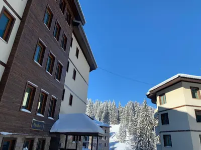 a view of the mountains from between two buildings at Evrika home 21 in Pamporovo
