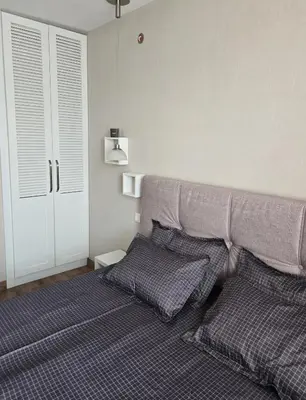 a bedroom with a bed with two pillows at Apartment at White Lavina Hotel in Bansko