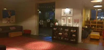 a room with a store with a couch and a window at Apartment at White Lavina Hotel in Bansko