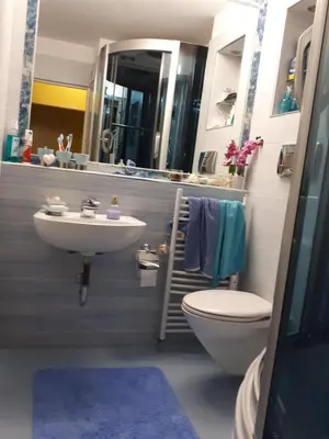 a bathroom with a sink and a toilet and a mirror at New York - Room for overnight travelers near the Airport, parking in Sofia