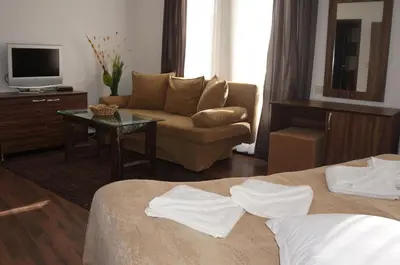 a hotel room with two beds and a couch at Boriki Complex in Pamporovo