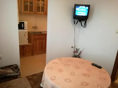a room with a table with a television on the wall at Blyan Family Hotel in Chiflik
