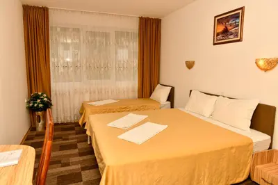 a hotel room with two beds and a window at Blyan Family Hotel in Chiflik