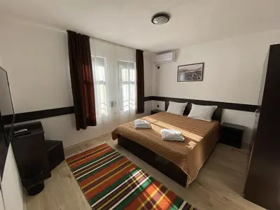 a bedroom with a bed with two towels on it at Апартхотел 