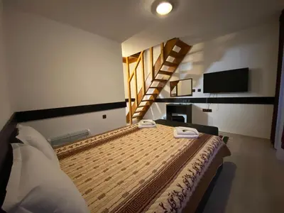 a bedroom with a bed with two towels on it at Апартхотел 