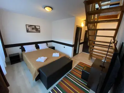 a small room with a bed and a staircase at Апартхотел 