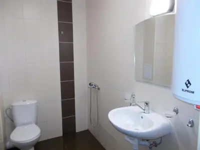 a bathroom with a toilet and a sink at Апартхотел 