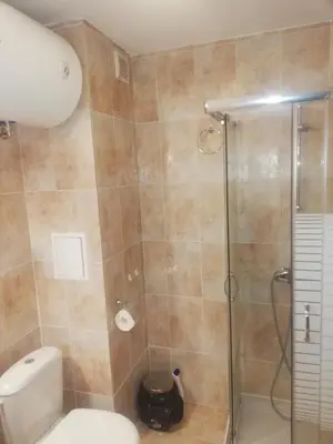 a bathroom with a shower and a toilet at Апартамент 109 Комплекс 