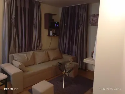 a living room with a couch and a table at Апартамент 109 Комплекс 