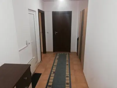a hallway with a black door and a tile floor at Апартамент 109 Комплекс 