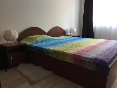 a bedroom with a bed with a colorful comforter at Ski 'Inn Monastery 3 Ski-to-Door in Pamporovo