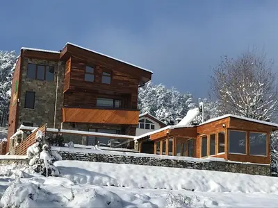 a house covered in snow in front of it at RELAX Guest House in Tsigov Chark