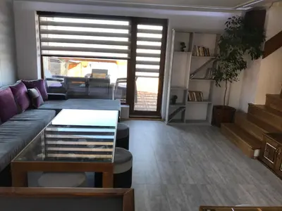 a living room with a couch and a table at RELAX Guest House in Tsigov Chark