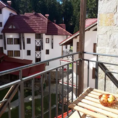 a balcony with a wooden bench and some buildings at Pamporovo Apartment 314 The Castle 3 in Pamporovo