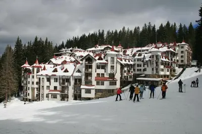 a group of people on skis in the snow at a resort at Pamporovo Apartment 314 The Castle 3 in Pamporovo