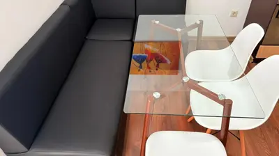 a glass table with two chairs and a bird on it at ASPEN GOLF RESORT K004 Ski & Spa RELAX APARTMENT in Razlog
