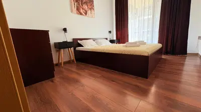 a bedroom with a bed and a wooden floor at ASPEN GOLF RESORT K004 Ski & Spa RELAX APARTMENT in Razlog