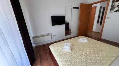 a room with a bed with two white towels on it at ASPEN GOLF RESORT K004 Ski & Spa RELAX APARTMENT in Razlog