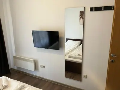 a mirror in a room with a tv and a bed at ASPEN GOLF RESORT K004 Ski & Spa RELAX APARTMENT in Razlog