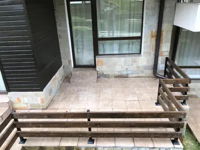 a wooden bench sitting outside of a building at ASPEN GOLF RESORT K004 Ski & Spa RELAX APARTMENT in Razlog