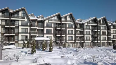 a large apartment building with snow on the ground at ASPEN GOLF RESORT K004 Ski & Spa RELAX APARTMENT in Razlog