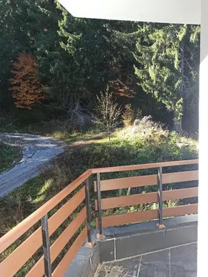 a wooden fence next to a dirt road at Private Apartments Nevena in Pamporovo