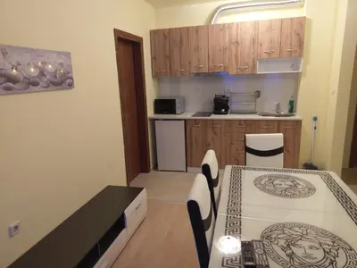 a kitchen with a table and a counter top at Private Apartments Nevena in Pamporovo