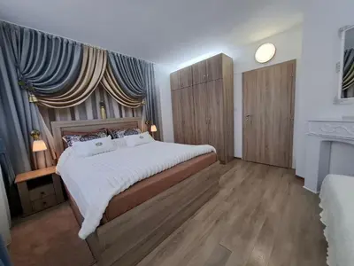 a bedroom with a large bed and a window at Apartment 15 in Borovets