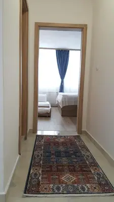 a hallway with a door to a bedroom with a rug at Apartment 15 in Borovets