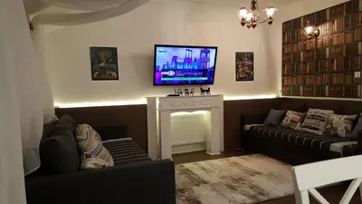 a living room with two couches and a flat screen tv at Apartment 15 in Borovets