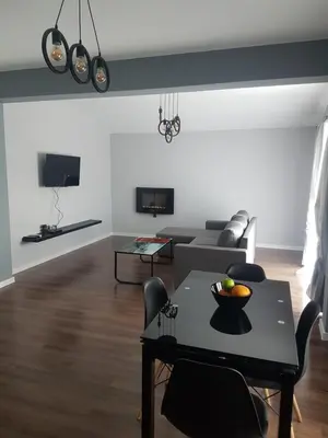 a living room with a table and a couch at LUXURY SUITES in Karlovo