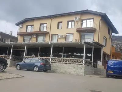 a building with cars parked in front of it at LUXURY SUITES in Karlovo