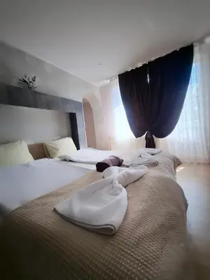a hotel room with two beds with towels on them at Стаи за гости Върбите in Sapareva Banya