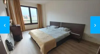 a bedroom with a bed and a large window at Terra Complex SPA apartment 1 bedroom suite in Razlog