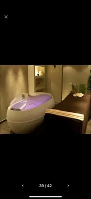 a bathroom with a purple bath tub next to a bed at Terra Complex SPA apartment 1 bedroom suite in Razlog